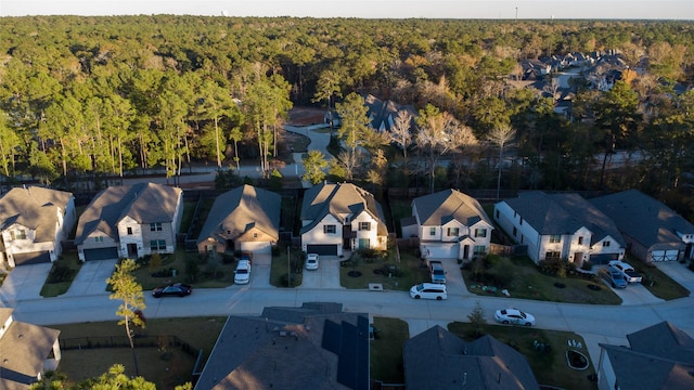 drone / aerial view with a residential view and a view of trees