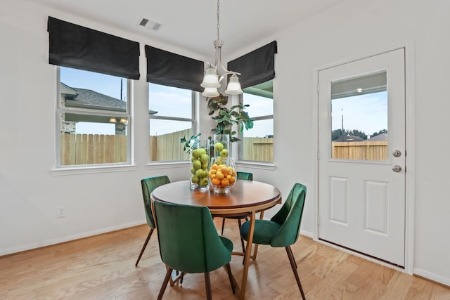 dining room with a chandelier and light hardwood / wood-style flooring