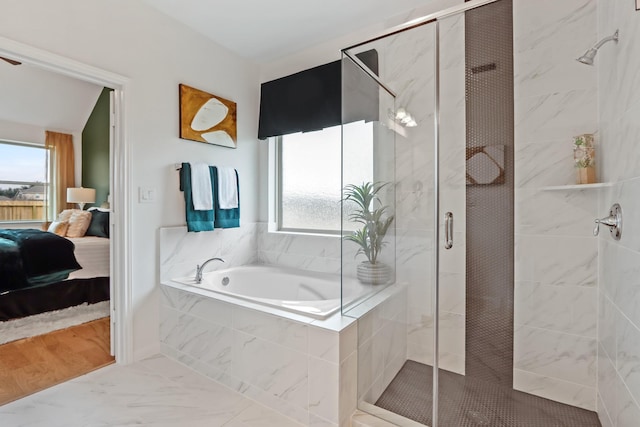 bathroom with hardwood / wood-style flooring, plenty of natural light, and independent shower and bath