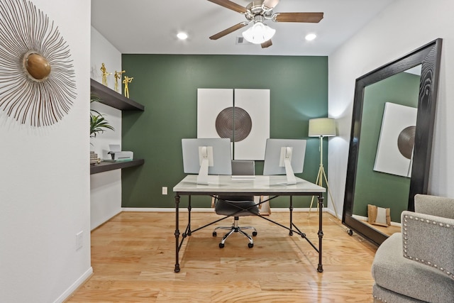 home office featuring light hardwood / wood-style floors and ceiling fan