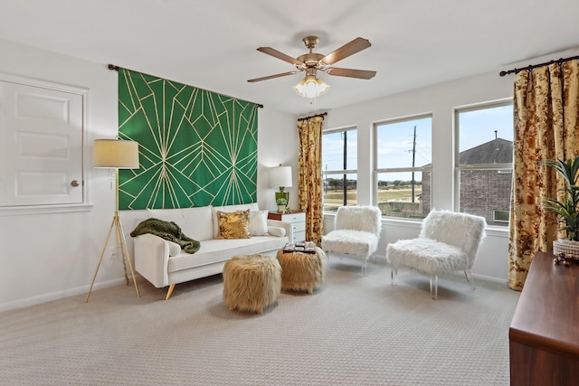 living area with carpet floors and ceiling fan