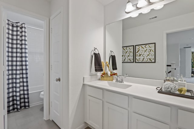 full bathroom featuring shower / bath combo, vanity, and toilet