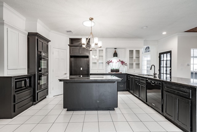 kitchen with ornamental molding, sink, black appliances, an inviting chandelier, and a center island