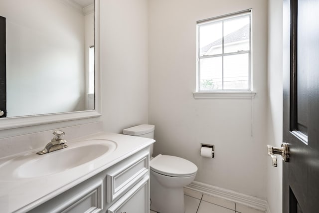 bathroom with toilet, vanity, tile patterned floors, and crown molding