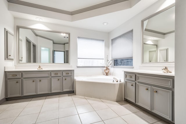 bathroom with vanity, tile patterned floors, a bathtub, and ornamental molding