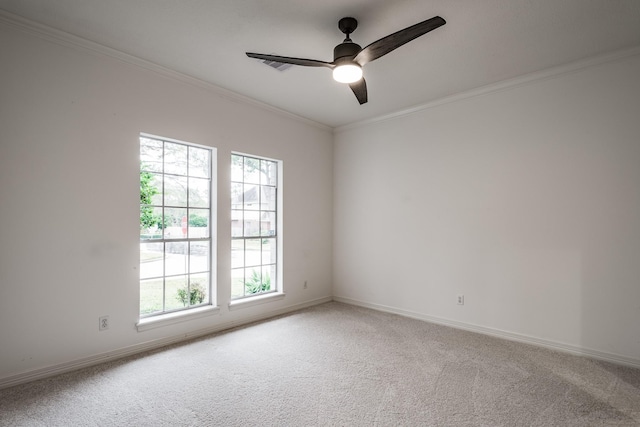 empty room with carpet flooring, ceiling fan, and crown molding