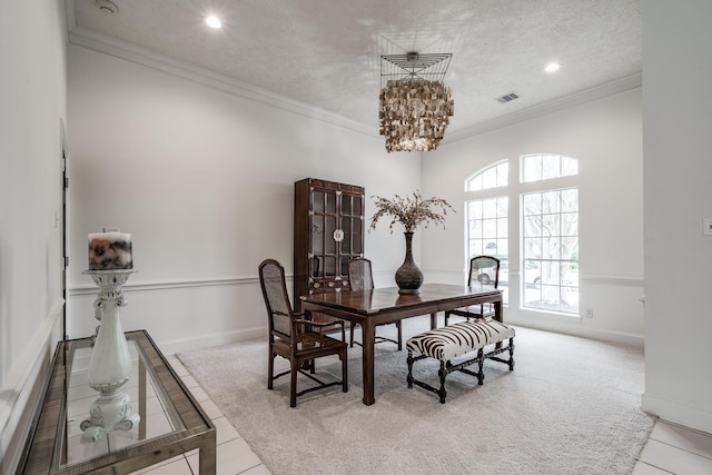 dining space with crown molding, light tile patterned floors, a textured ceiling, and a notable chandelier