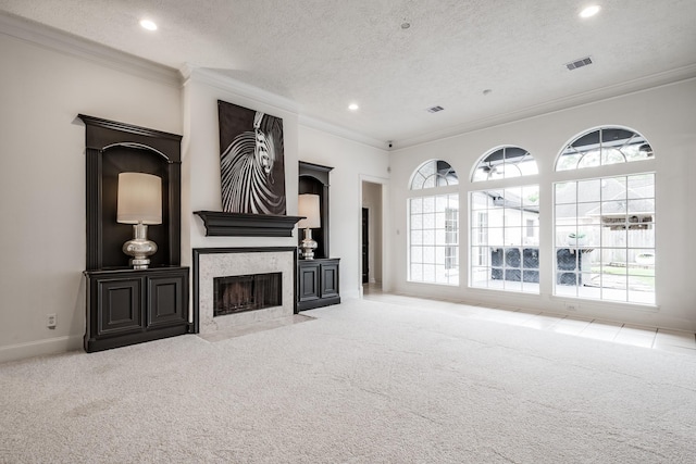 carpeted living room with a textured ceiling and ornamental molding