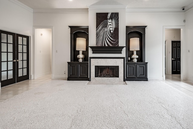 living room with a fireplace, crown molding, french doors, and carpet floors