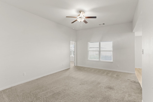 empty room featuring carpet and ceiling fan