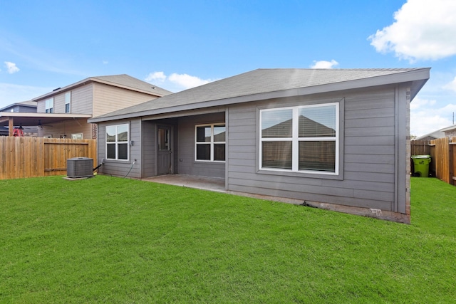 back of property featuring a yard, central AC, and a patio area