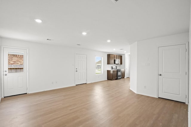 unfurnished living room featuring light wood-type flooring