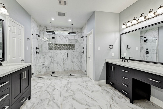 bathroom featuring tiled shower and vanity