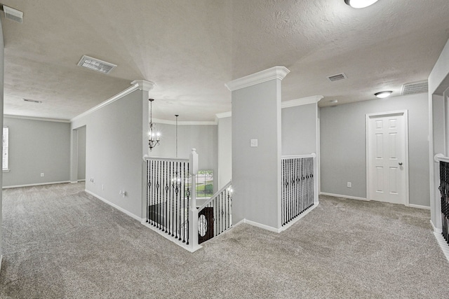 hallway featuring light carpet, a textured ceiling, and ornamental molding