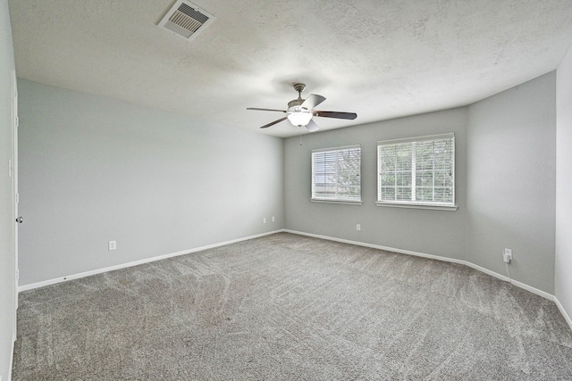 unfurnished room with carpet, ceiling fan, and a textured ceiling