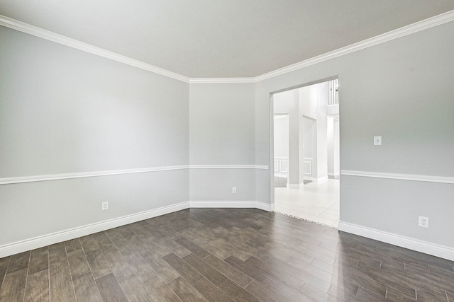 spare room with crown molding and dark hardwood / wood-style flooring