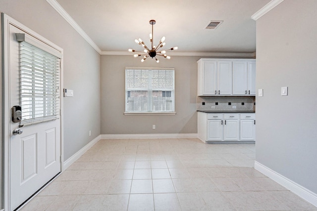 unfurnished dining area with light tile patterned floors, ornamental molding, and a notable chandelier