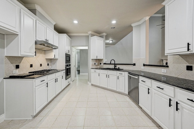 kitchen featuring dark stone countertops, white cabinetry, ornamental molding, and appliances with stainless steel finishes