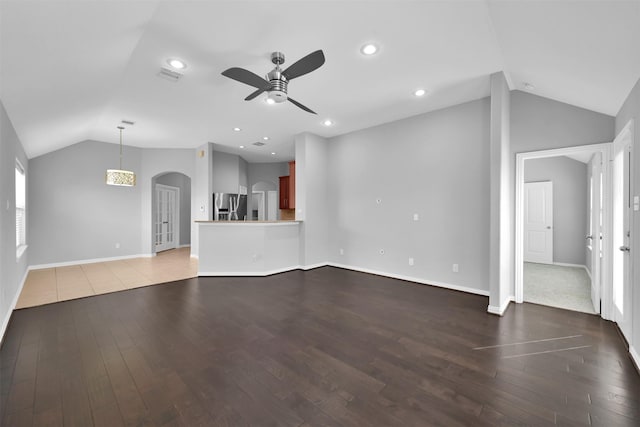 unfurnished living room with ceiling fan, lofted ceiling, and hardwood / wood-style flooring