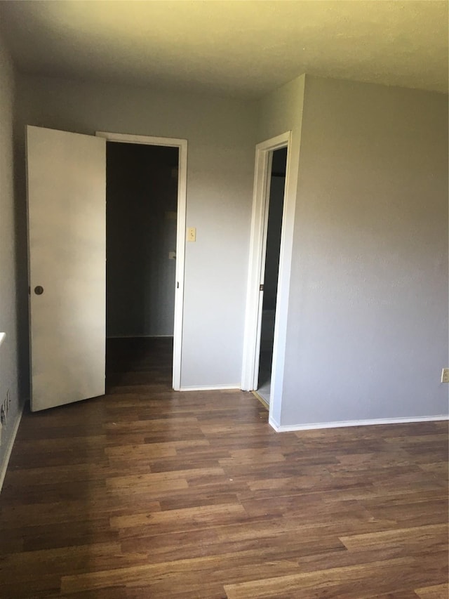 spare room with dark hardwood / wood-style flooring