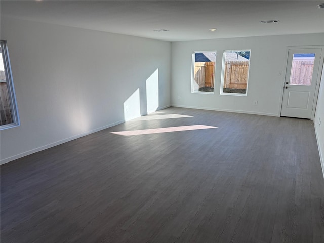 spare room featuring dark hardwood / wood-style flooring