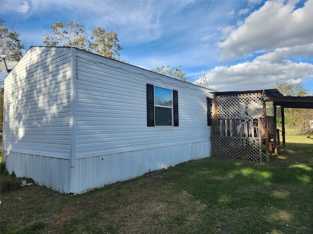 view of side of property with a lawn