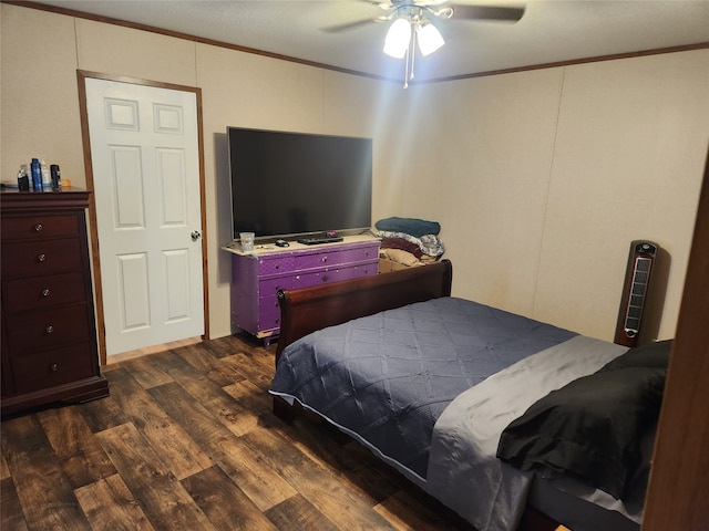 bedroom featuring ceiling fan, dark hardwood / wood-style flooring, and crown molding