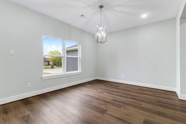 unfurnished dining area featuring a notable chandelier and dark wood-type flooring