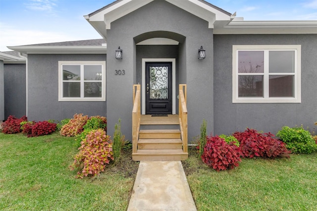 property entrance with a yard