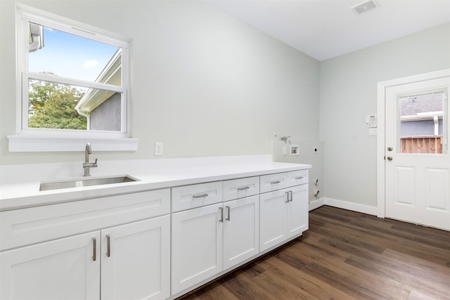 washroom featuring cabinets, sink, washer hookup, dark hardwood / wood-style floors, and hookup for an electric dryer