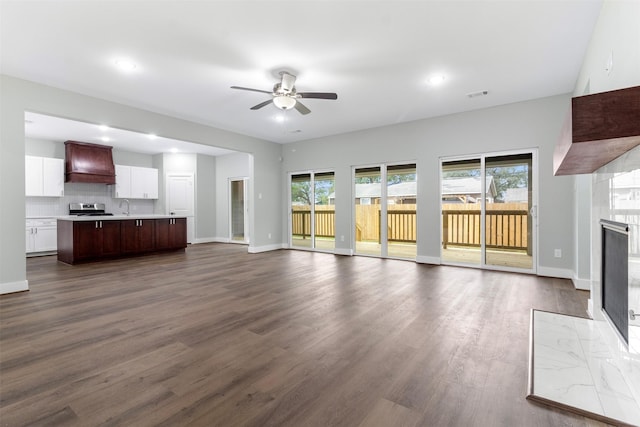 303 Kalmer St, Pasadena, TX 77502 - unfurnished living room with a ceiling fan, a tile fireplace, plenty of natural light, dark wood-type flooring, and recessed lighting