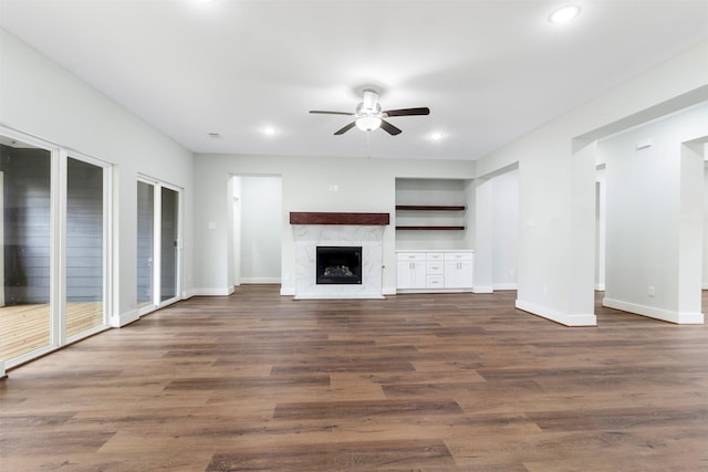 303 Kalmer St, Pasadena, TX 77502 - unfurnished living room with a ceiling fan, dark wood-type flooring, recessed lighting, a premium fireplace, and built in shelves