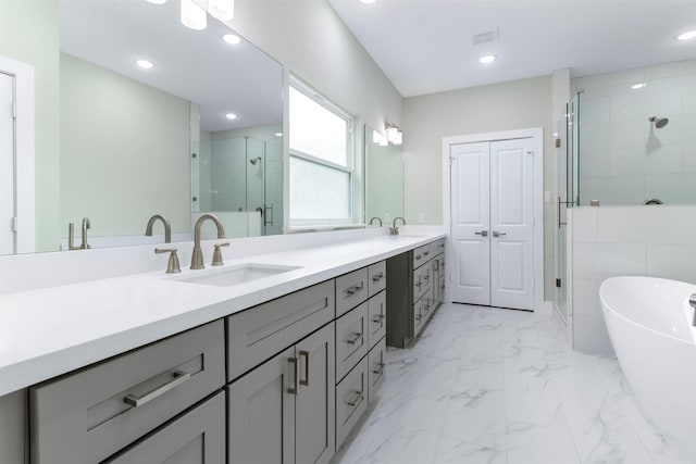 303 Kalmer St, Pasadena, TX 77502 - bathroom featuring double vanity, a shower stall, a soaking tub, marble look tiles, and recessed lighting