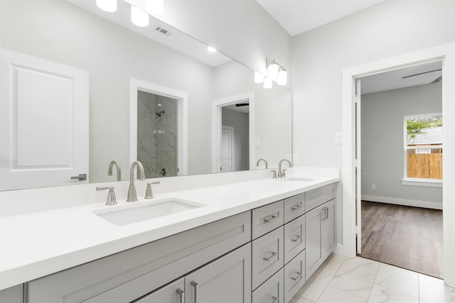 bathroom with vanity, wood-type flooring, and walk in shower