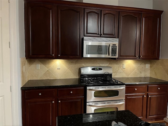 kitchen featuring decorative backsplash, dark stone countertops, and stainless steel appliances