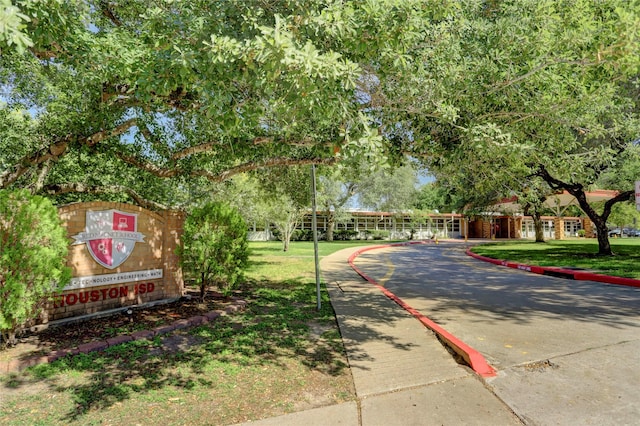 view of property's community with a lawn