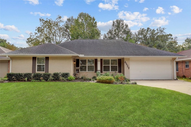 ranch-style house featuring a front yard and a garage