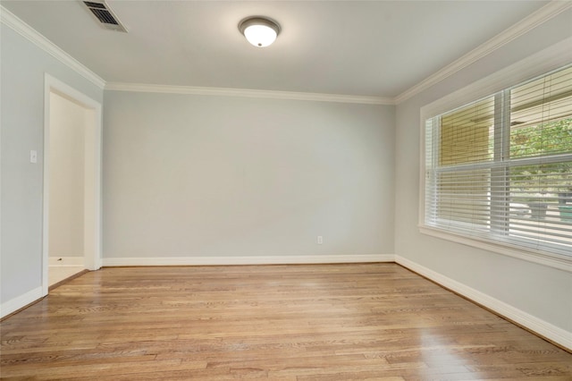 unfurnished room featuring light hardwood / wood-style flooring and crown molding