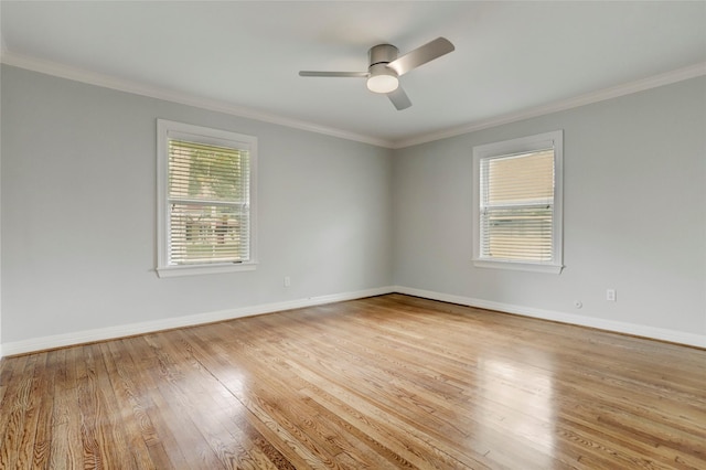 empty room with ornamental molding, a healthy amount of sunlight, and light wood-type flooring