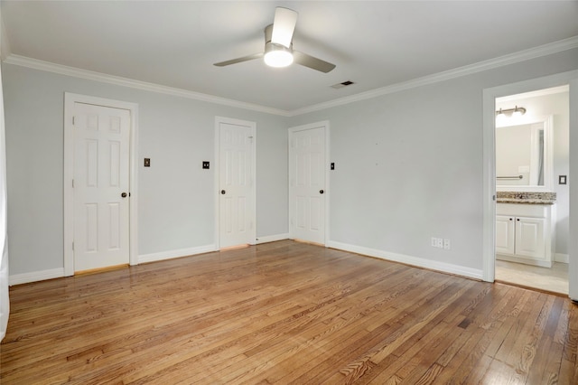 unfurnished bedroom featuring ceiling fan, light hardwood / wood-style flooring, ensuite bathroom, and ornamental molding