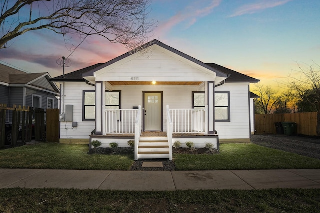 bungalow featuring a lawn and a porch