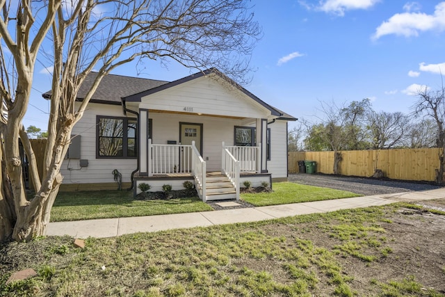 bungalow-style house with a front lawn and covered porch