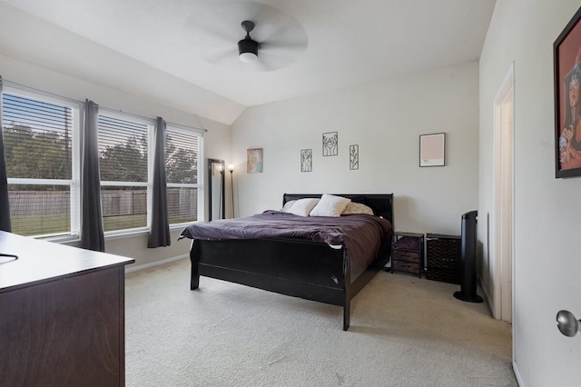 bedroom featuring light carpet, vaulted ceiling, and ceiling fan