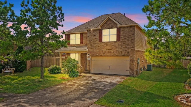 view of front of house with a yard, a garage, and cooling unit