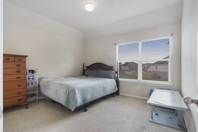 carpeted bedroom featuring lofted ceiling