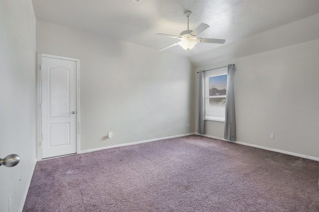 carpeted empty room with ceiling fan and vaulted ceiling