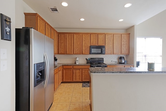 kitchen featuring black appliances, light tile patterned floors, and tasteful backsplash