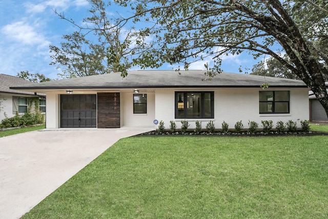 single story home with a garage and a front lawn