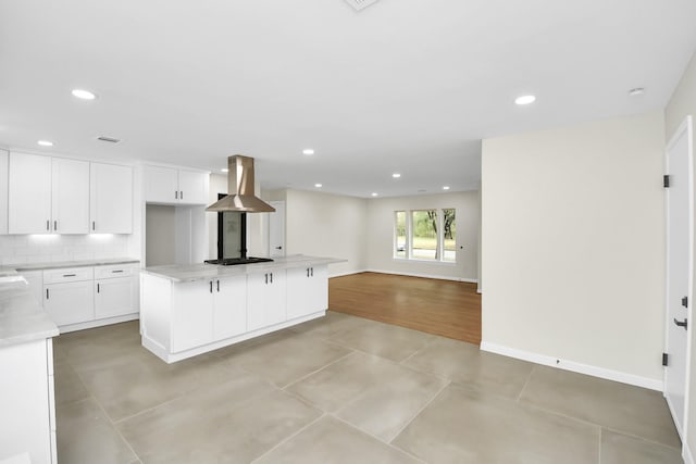 kitchen with a center island, backsplash, island exhaust hood, black gas stovetop, and white cabinets