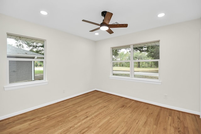 spare room with ceiling fan and light hardwood / wood-style flooring